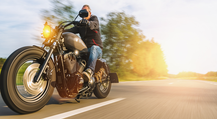 Rider on black motorcycle enjoying a safe ride with full coverage motorcycle insurance in Ohio