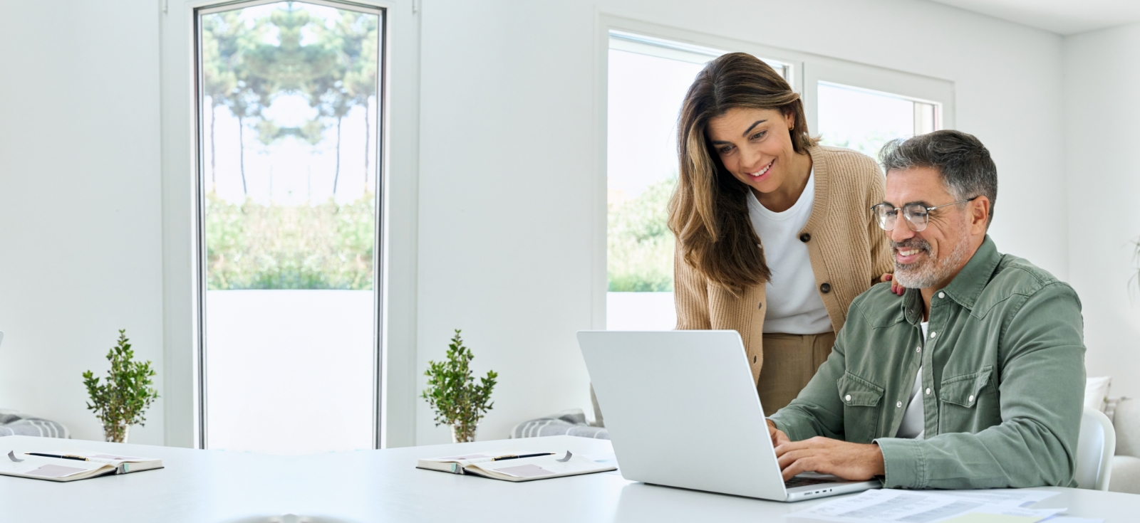 Smiling couple reviewing insurance options and exploring the best fit for their coverage needs with J. Fox Agency.